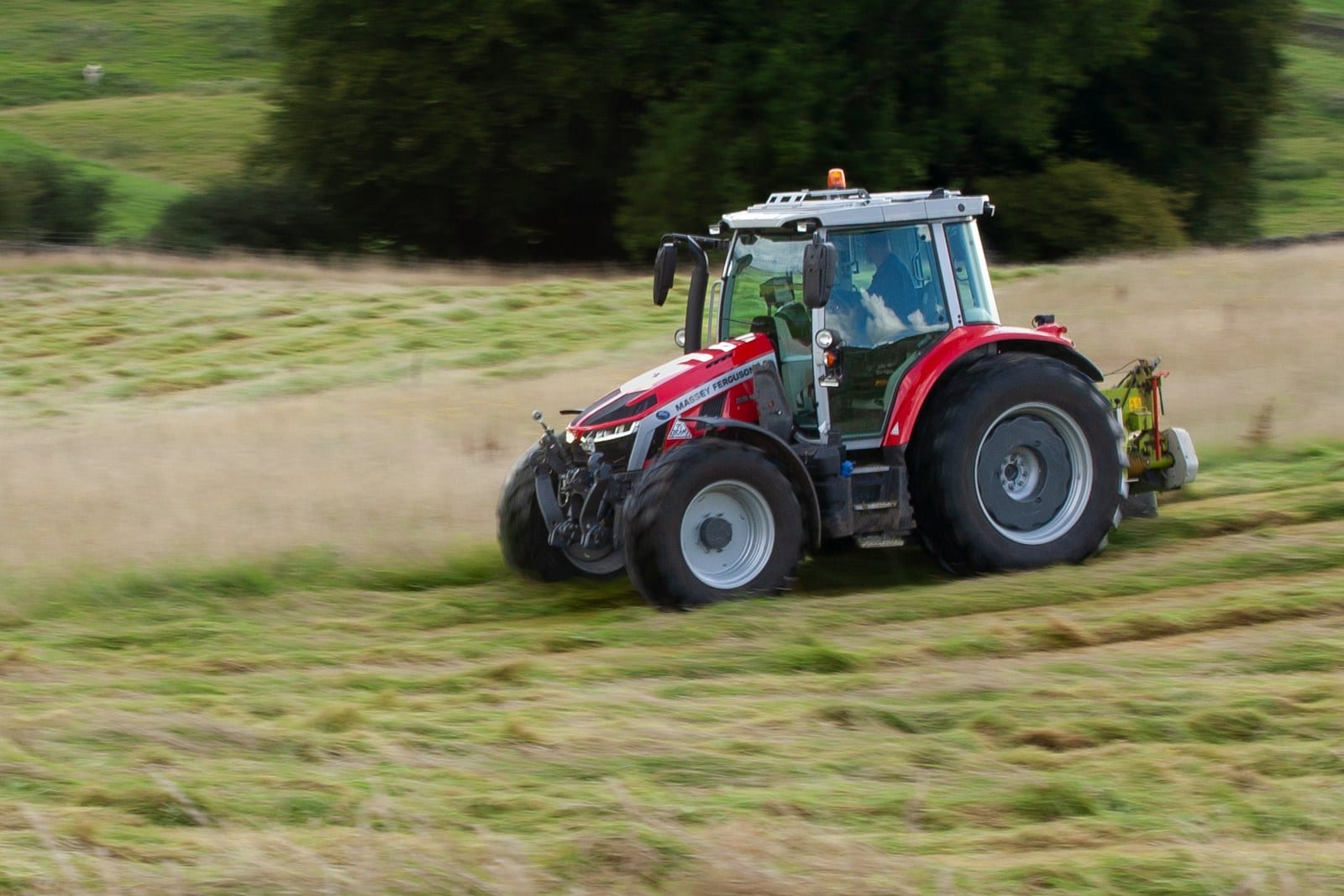 Tractor mowing a roadside ditch